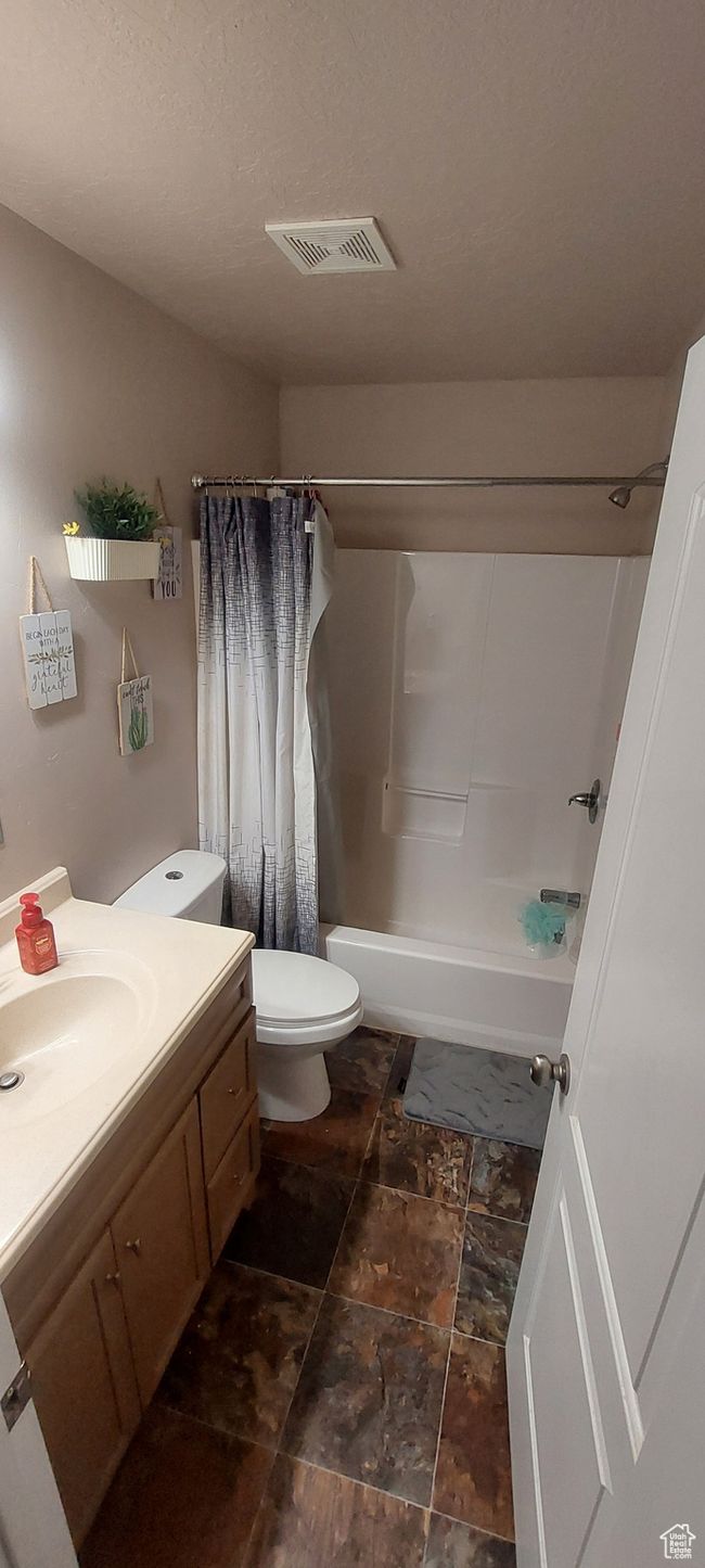 Bathroom featuring vanity and shower / tub combo | Image 8