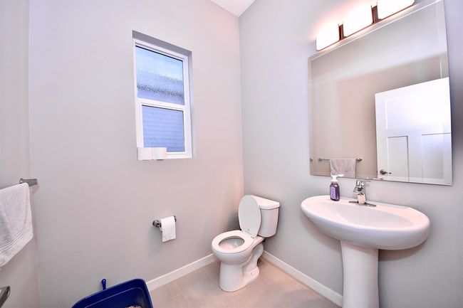 Half bathroom featuring toilet, baseboards, and tile patterned flooring | Image 13