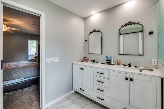 Full bath featuring ensuite bathroom, double vanity, marble finish floors, and ceiling fan | Image 16