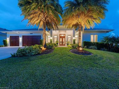 Evening view of front of property featuring a garage and a front lawn | Image 2