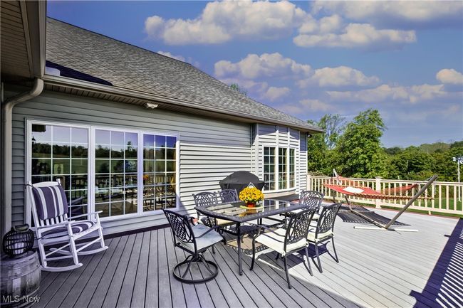 Wooden terrace featuring grilling area and outdoor dining area | Image 13