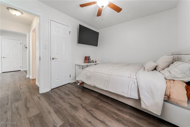 Bedroom featuring baseboards, ceiling fan, and wood finished floors | Image 23