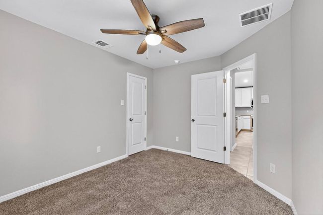 Unfurnished bedroom with light carpet and a ceiling fan | Image 27