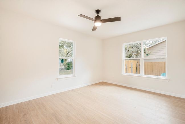 Unfurnished room featuring light wood-type flooring and ceiling fan | Image 21