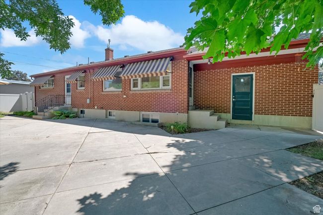 Back of property with a chimney, brick siding, and a patio area | Image 30