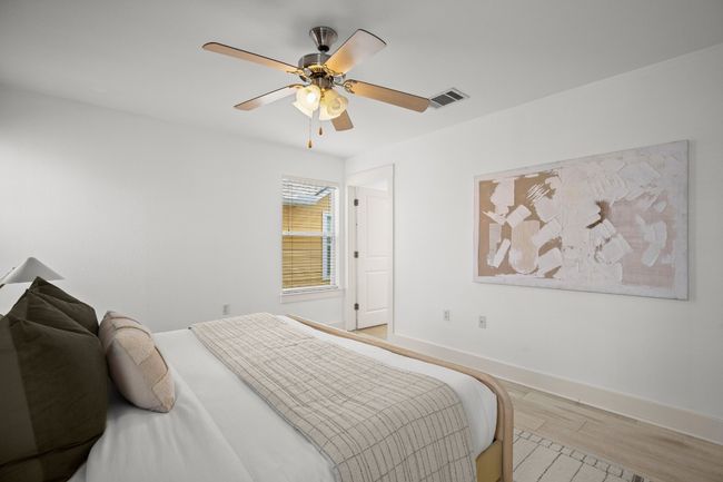 Bedroom featuring light wood-type flooring and a ceiling fan | Image 10