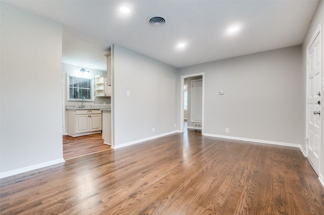 Living living room with real wood finished floors, baseboards, recessed lighting, and a sink | Image 8