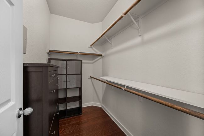 Walk in closet with dark wood-style floors | Image 20