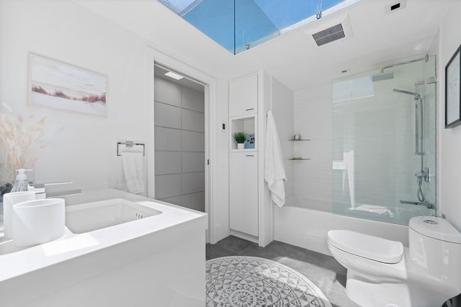 Bathroom with shower / bathtub combination, tile patterned flooring, and vanity | Image 16