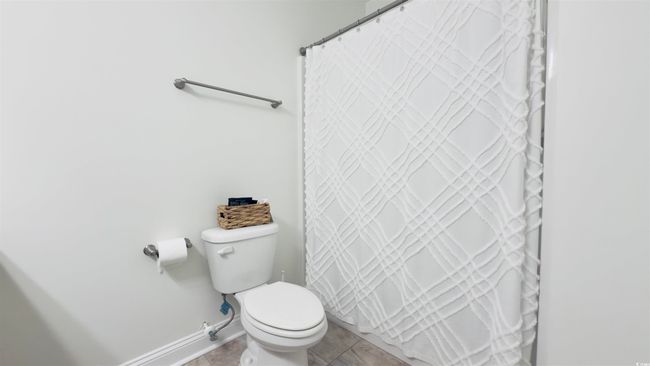 Full bath with a shower with shower curtain and tile patterned flooring | Image 29