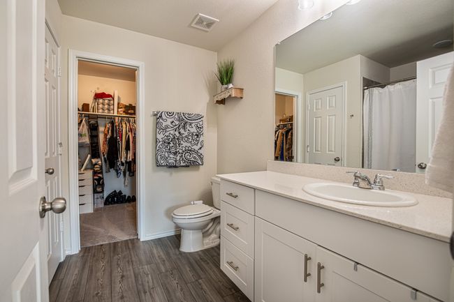 Full bathroom with a spacious closet, vanity, and wood finished floors | Image 16