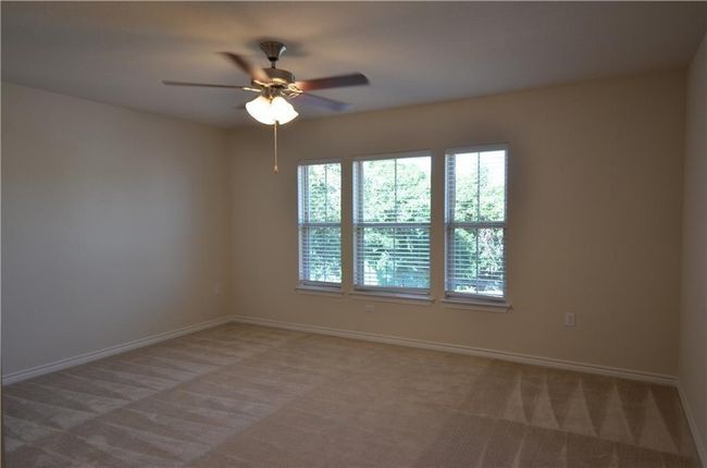 Unfurnished room featuring carpet and a ceiling fan | Image 17