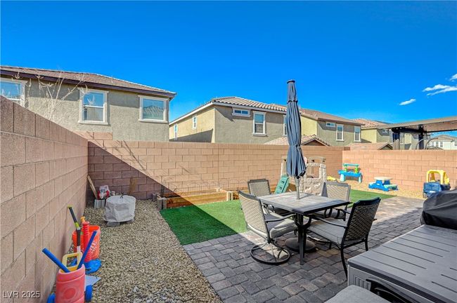Fenced backyard featuring a patio and outdoor dining area | Image 54