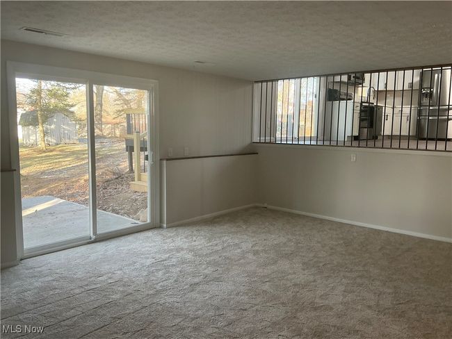 Carpeted empty room with a textured ceiling | Image 6