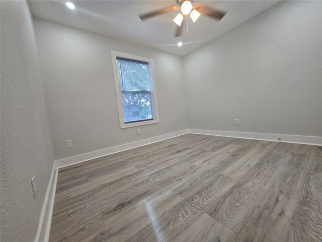 Unfurnished room featuring wood finished floors, a ceiling fan, and recessed lighting | Image 12