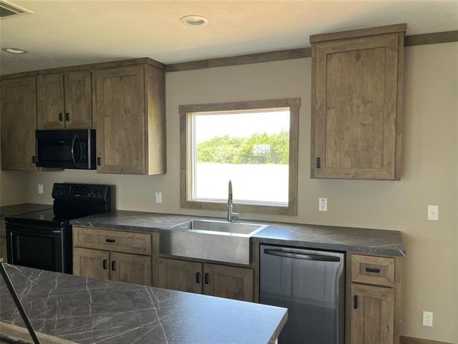 The open floor plan adds to the inviting atmosphere of the home, a split floor plan with the kitchen open to the living room. | Image 6