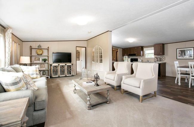 Living area with wood finished floors and ornamental molding | Image 6