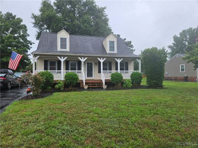 Cape cod home featuring a porch and a front lawn | Image 2