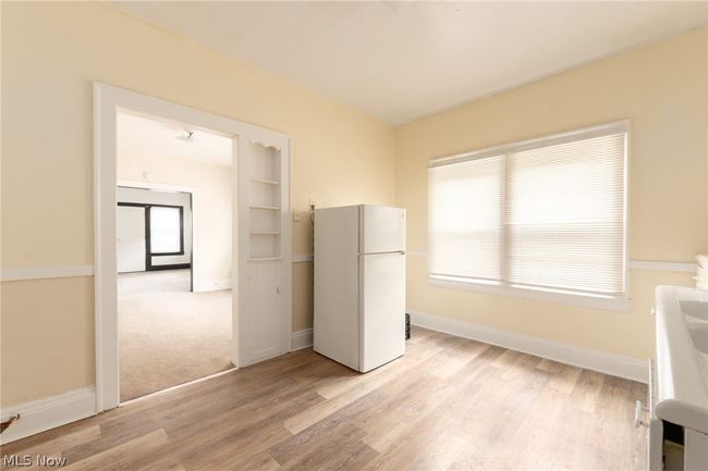 Unfurnished bedroom with white fridge and light hardwood / wood-style flooring | Image 11