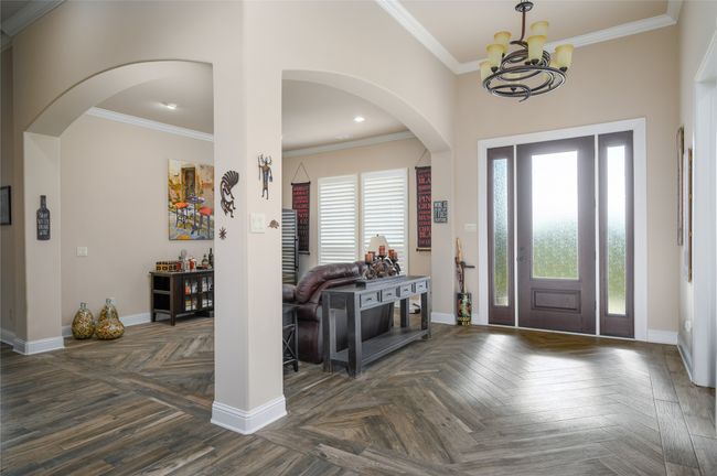 Entry with dining room which has been repurposed to sitting area. | Image 6