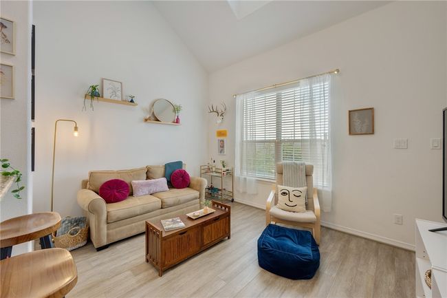 Living room with light wood-style floors and lofted ceiling | Image 5