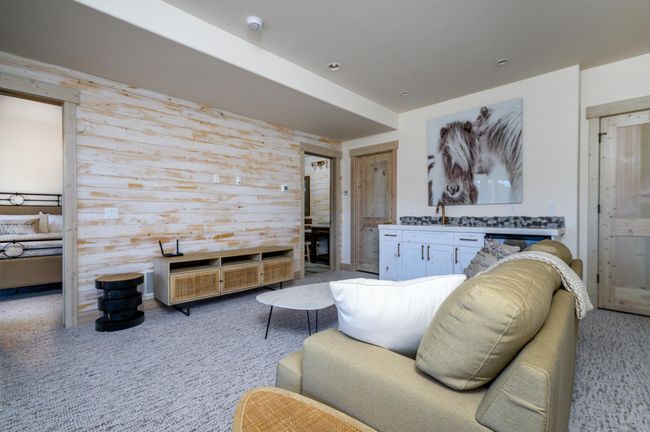 Lower level entertainment room with a wet bar and seamless outdoor access | Image 22