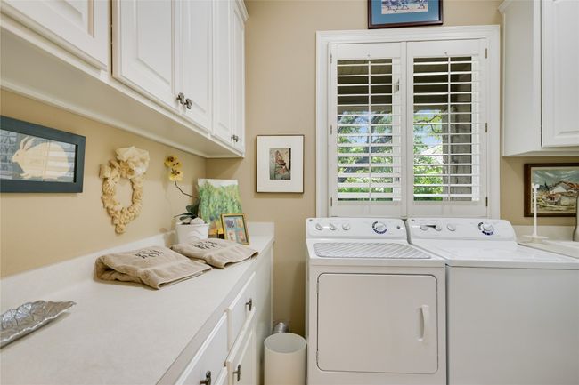 Laundry room with cabinets | Image 16