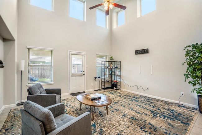 The family room is huge and has lots of windows that stream in natural light. | Image 17