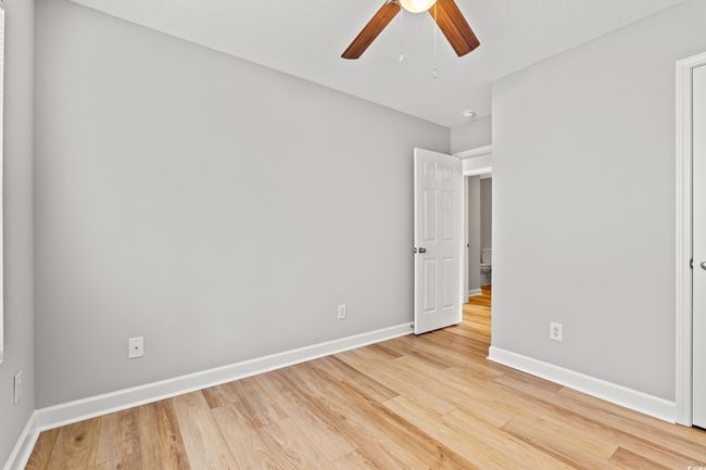 Unfurnished bedroom with light wood finished floors and ceiling fan | Image 22