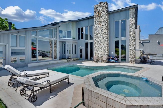 Pool with a patio area and an in ground hot tub | Image 31