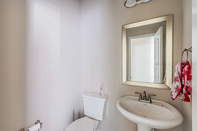 Bathroom featuring a sink and toilet | Image 16