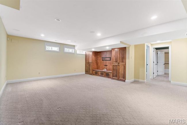Unfurnished living room with light colored carpet and recessed lighting | Image 50