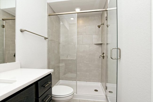 Full bath with a stall shower, toilet, and vanity | Image 25