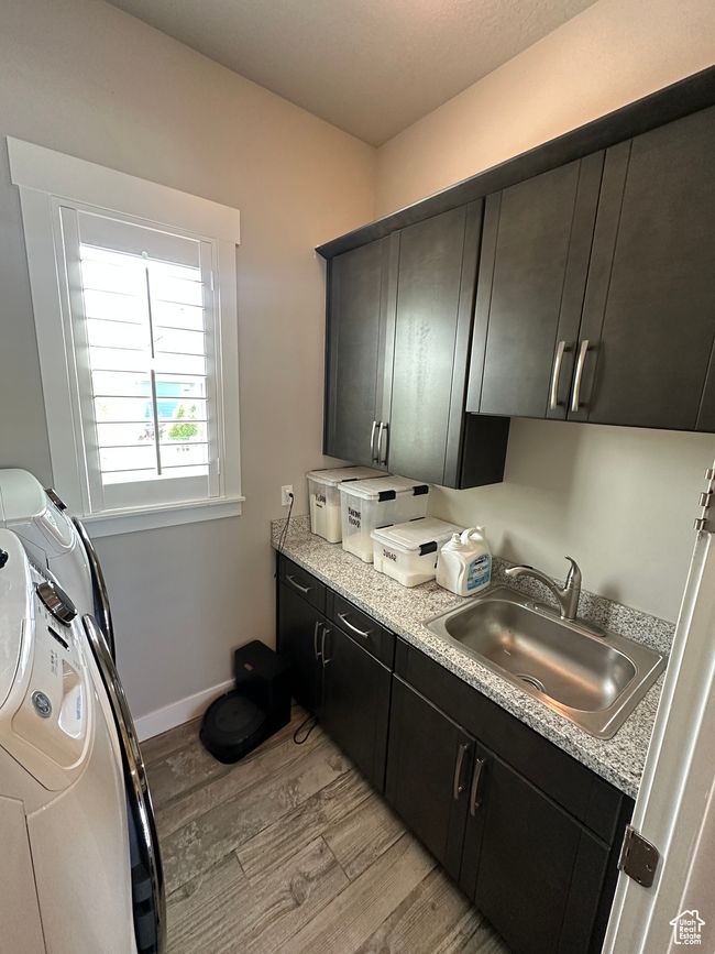 Laundry area with counter and cabinet space with deep sink. | Image 19