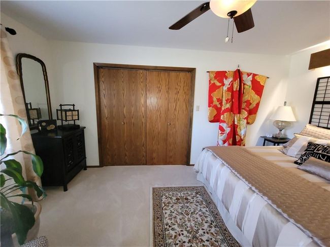 Bedroom featuring a closet, ceiling fan, and carpet | Image 46