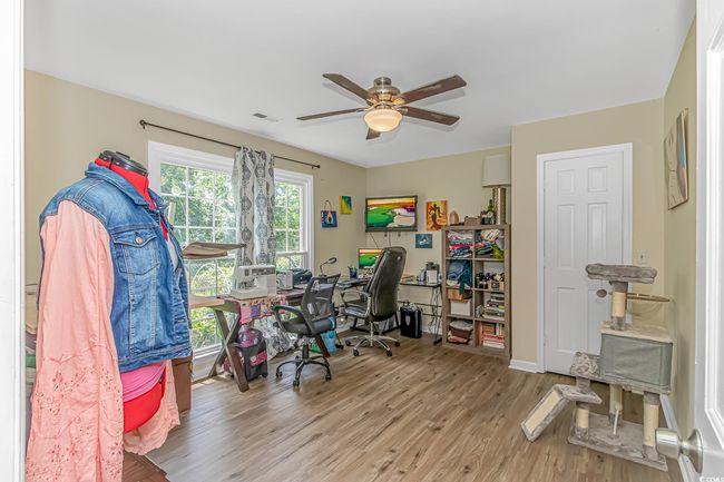 Office space with a ceiling fan and wood finished floors | Image 18