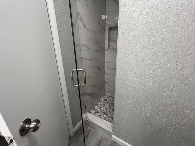 Full bathroom with a stall shower and baseboards | Image 15