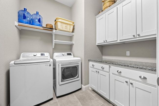 Large laundry room with built-in cabinetry and shelving | Image 27