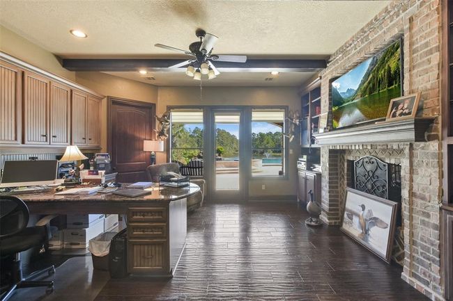 One of the offices has a fireplace and views of the pool and lake | Image 27