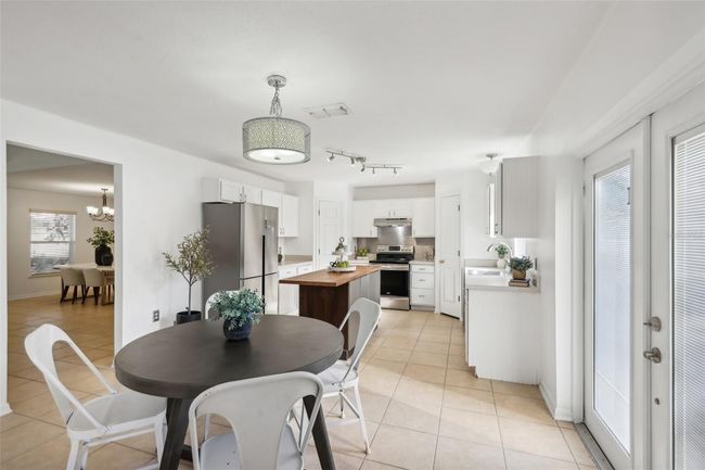 Dinette and double French Doors with interior blinds to the backyard. | Image 6