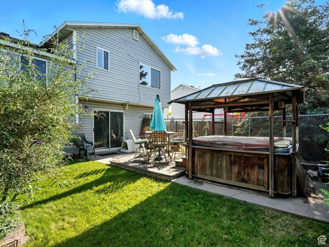 Rear view of house with a hot tub, a gazebo, and a patio | Image 24