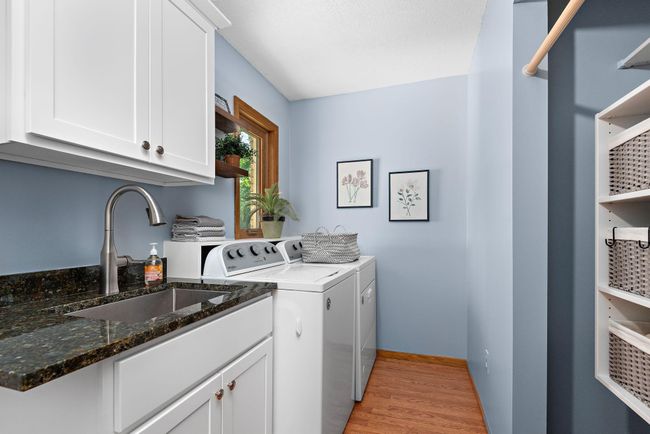 Remodeled main level laundry room with sink and closet for storage. | Image 18