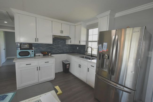 Range installation underway—fully equipped kitchen included! | Image 10