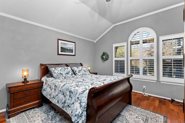 Bedroom featuring ornamental molding, lofted ceiling, ceiling fan, and light hardwood / wood-style flooring | Image 22