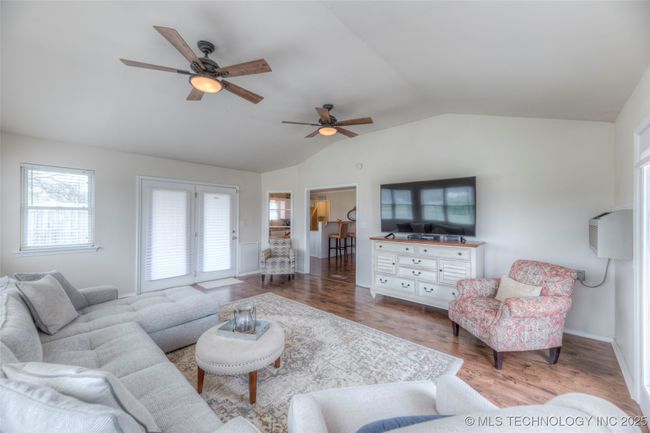 Living Room also features wood floors continued from the entry, dining and kitchen spaces. | Image 16
