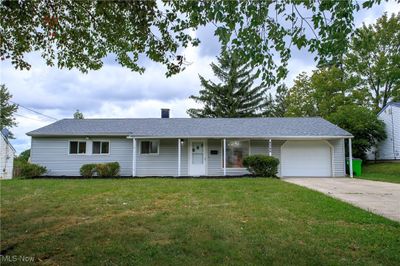 Ranch-style home with a garage and a front yard | Image 1