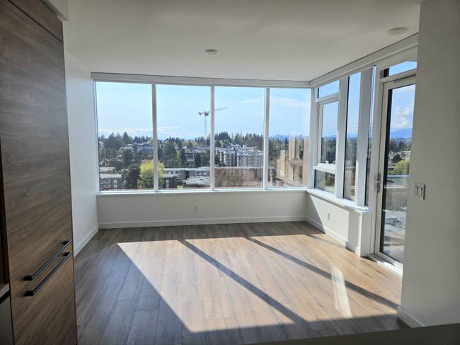 Unfurnished sunroom featuring wood finished floors and baseboards | Image 14