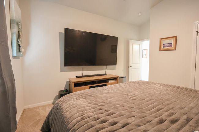 Bedroom with vaulted ceiling, light colored carpet, and baseboards | Image 21