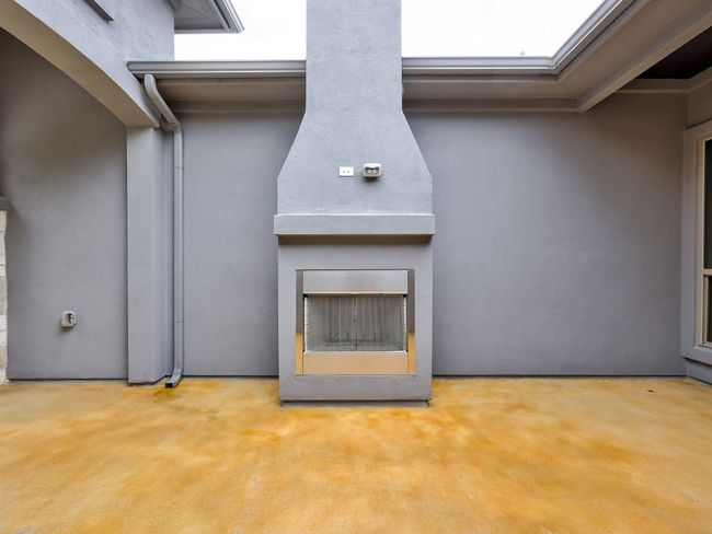 View of courtyard fireplace that has never been used | Image 37