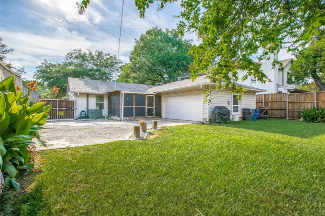 Back of house with a sunroom, a garage, driveway | Image 25